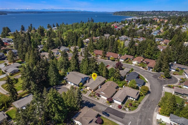 view of property location featuring nearby suburban area and a water and mountain view