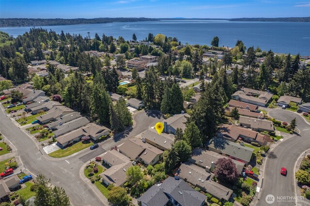 aerial view of property and surrounding area with nearby suburban area and a nearby body of water