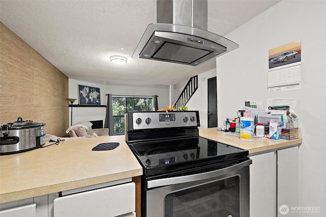4008 S 158th St Unit J, Tukwila, WA 98188 - kitchen with a textured ceiling, light countertops, stainless steel range with electric cooktop, and wall chimney exhaust hood