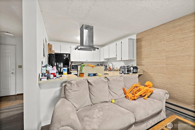 4008 S 158th St Unit J, Tukwila, WA 98188 - kitchen featuring freestanding refrigerator, a textured ceiling, a sink, island exhaust hood, and white cabinets
