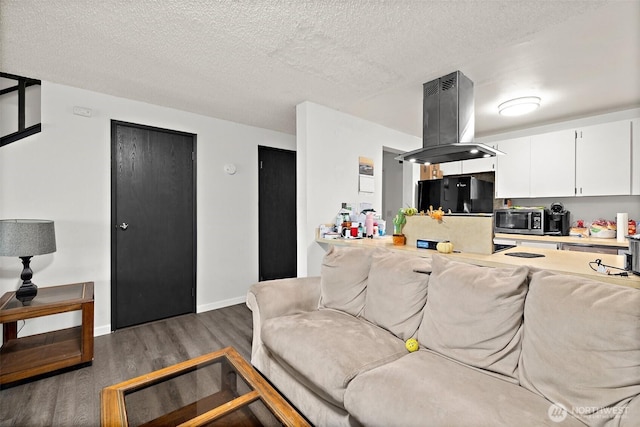 4008 S 158th St Unit J, Tukwila, WA 98188 - living room featuring baseboards, a textured ceiling, and wood finished floors