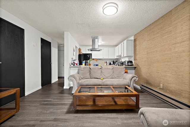 4008 S 158th St Unit J, Tukwila, WA 98188 - living area featuring a baseboard radiator, a textured ceiling, baseboards, and wood finished floors