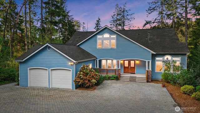 161 E Heron Cv, Shelton, WA 98584 - view of front of house featuring french doors, covered porch, an attached garage, and decorative driveway