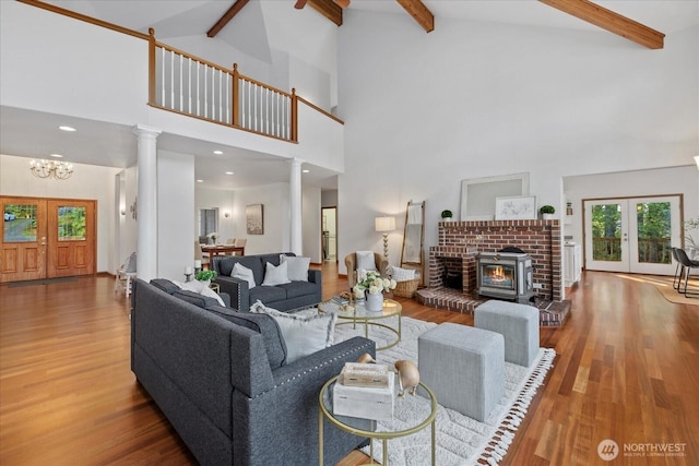 161 E Heron Cv, Shelton, WA 98584 - living area with an inviting chandelier, high vaulted ceiling, french doors, decorative columns, and wood finished floors