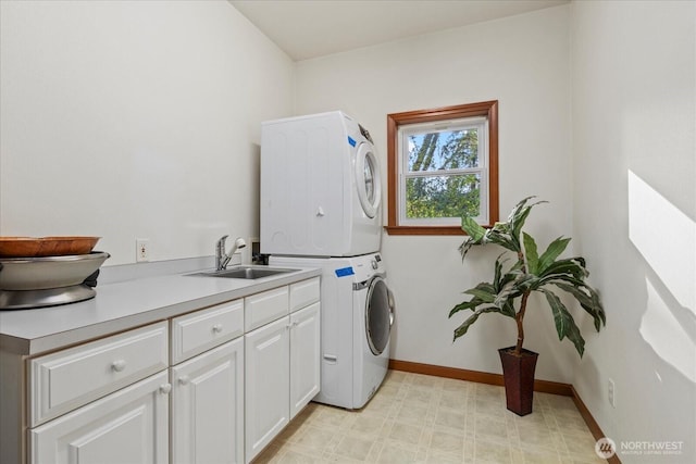 161 E Heron Cv, Shelton, WA 98584 - washroom featuring stacked washer / drying machine, cabinet space, a sink, baseboards, and light floors