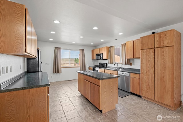 kitchen with a center island, recessed lighting, a sink, and stainless steel appliances