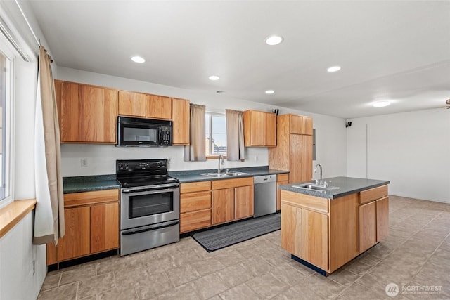 kitchen featuring a sink, appliances with stainless steel finishes, and dark countertops