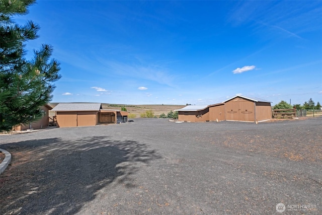 view of street with an outbuilding and driveway