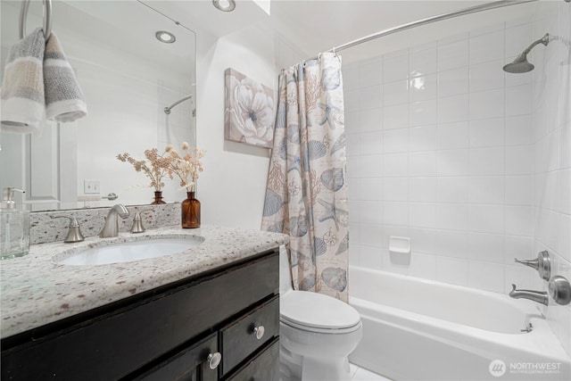 bathroom with vanity, shower / bath combo, and toilet