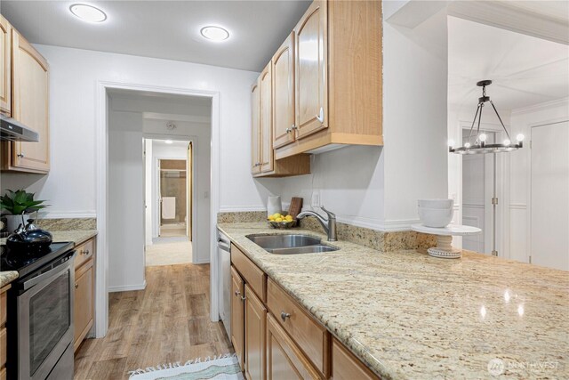 kitchen with a sink, light stone counters, light wood-style floors, and stainless steel range with electric cooktop