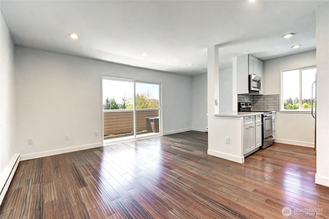 12429 NE 130th Ct Unit G201, Kirkland, WA 98034 - kitchen with stainless steel appliances, open floor plan, baseboard heating, and a healthy amount of sunlight