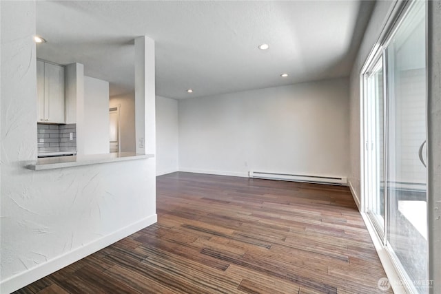 12429 NE 130th Ct Unit G201, Kirkland, WA 98034 - unfurnished living room featuring baseboards, baseboard heating, recessed lighting, and wood finished floors