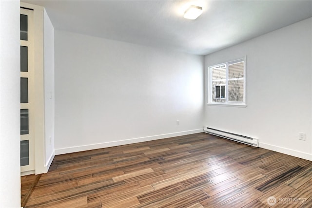 12429 NE 130th Ct Unit G201, Kirkland, WA 98034 - spare room featuring baseboards, baseboard heating, and wood finished floors