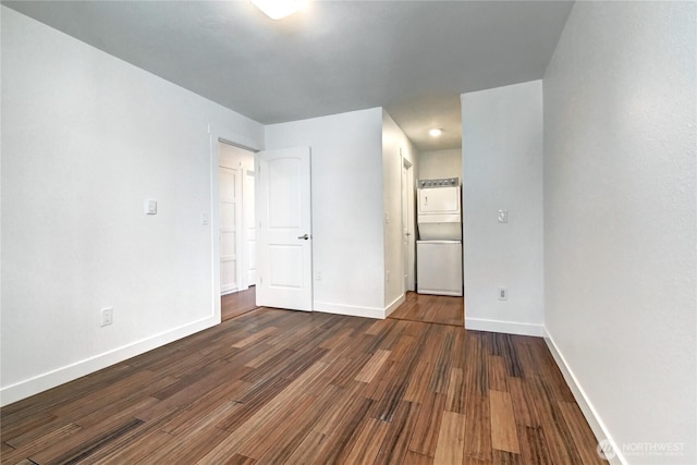 12429 NE 130th Ct Unit G201, Kirkland, WA 98034 - spare room featuring baseboards, stacked washer and clothes dryer, and dark wood-style floors