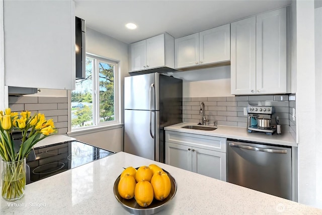 12429 NE 130th Ct Unit G201, Kirkland, WA 98034 - kitchen featuring a sink, stainless steel appliances, white cabinetry, and decorative backsplash