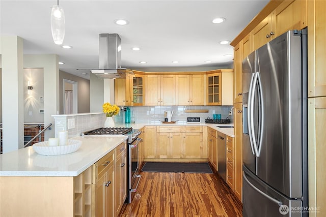 kitchen with island range hood, light brown cabinetry, appliances with stainless steel finishes, a peninsula, and dark wood-type flooring