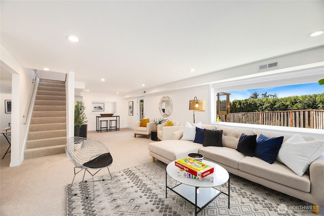 carpeted living room featuring stairs, recessed lighting, and visible vents