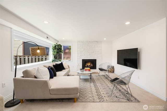 living room featuring carpet floors, recessed lighting, baseboards, and a fireplace