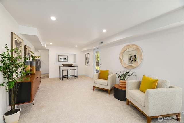 sitting room with recessed lighting, baseboards, visible vents, and light colored carpet