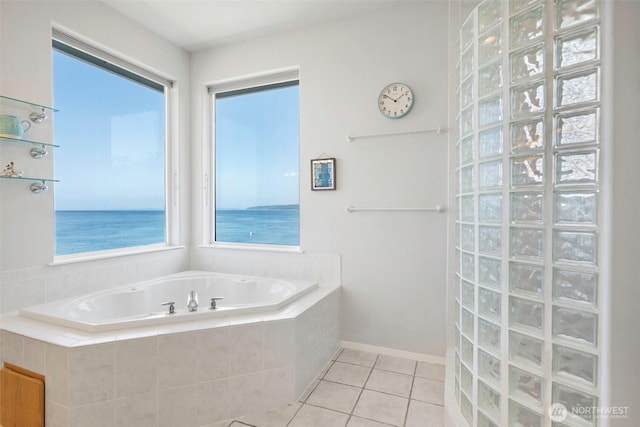 bathroom featuring a walk in shower, tile patterned floors, baseboards, and a bath