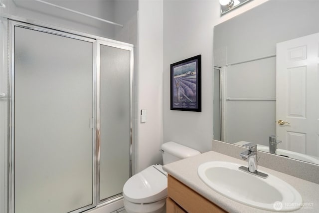 full bathroom with vanity, toilet, and a stall shower
