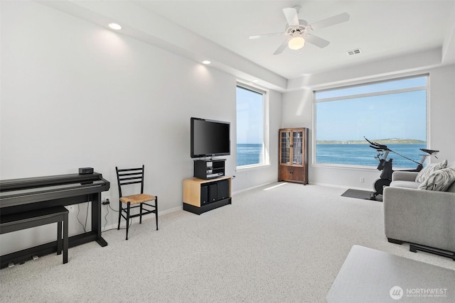 carpeted living room featuring baseboards, a ceiling fan, recessed lighting, and visible vents