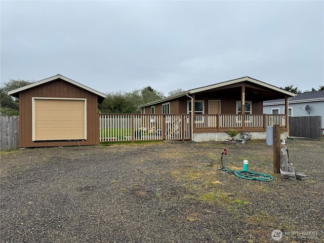 manufactured / mobile home featuring fence and an outbuilding