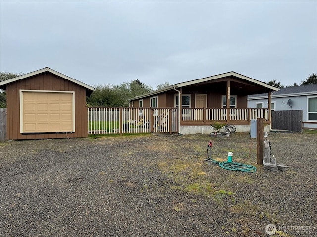 manufactured / mobile home featuring fence and an outbuilding