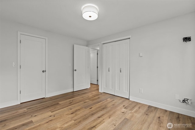 unfurnished bedroom with baseboards and light wood finished floors