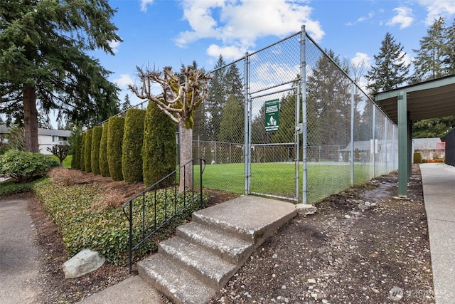 view of property's community featuring fence and a gate