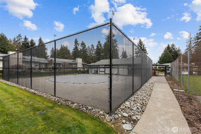 view of tennis court featuring fence