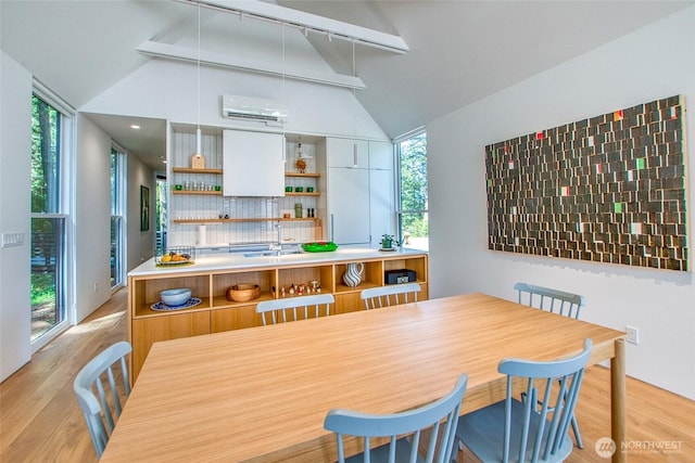 51 Lakshmi Rd, Orcas Island, WA 98245 - dining room with a wall mounted air conditioner and light wood-type flooring