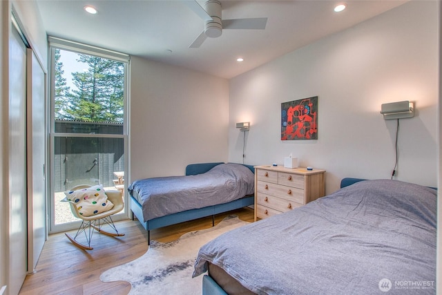 51 Lakshmi Rd, Orcas Island, WA 98245 - bedroom with wood finished floors, recessed lighting, a ceiling fan, and a wall of windows