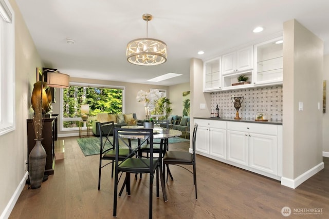 dining room featuring baseboards, a notable chandelier, recessed lighting, and dark wood-type flooring