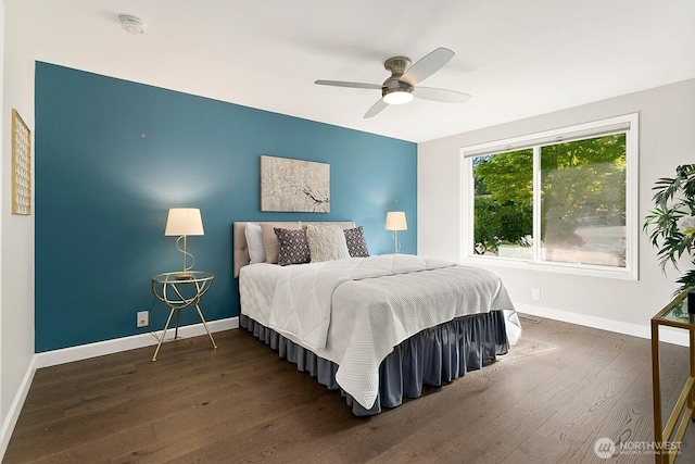 bedroom with baseboards, a ceiling fan, and wood finished floors
