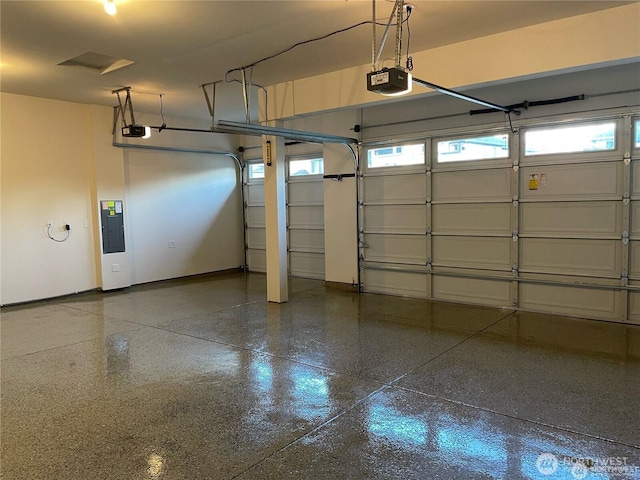 garage featuring baseboards, a garage door opener, and electric panel