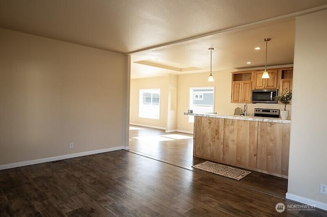 kitchen featuring dark wood-style flooring, baseboards, recessed lighting, hanging light fixtures, and stainless steel appliances