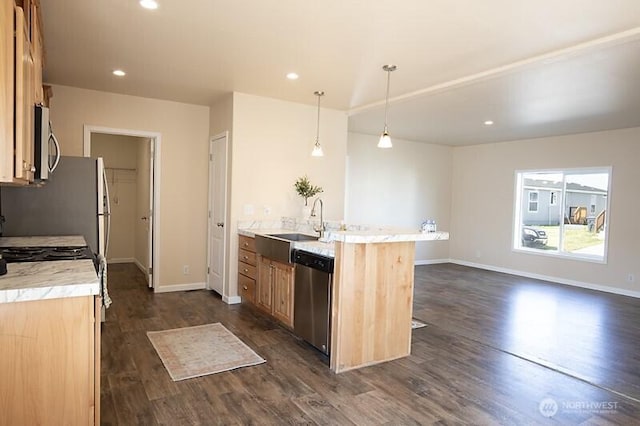 kitchen with dark wood-style flooring, baseboards, light countertops, a sink, and appliances with stainless steel finishes