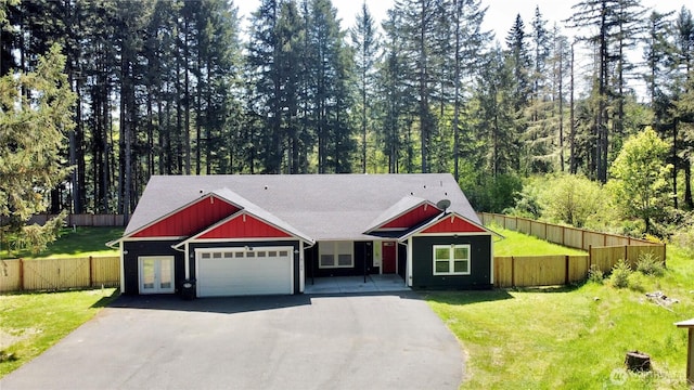 craftsman inspired home featuring a garage, board and batten siding, driveway, and a front yard