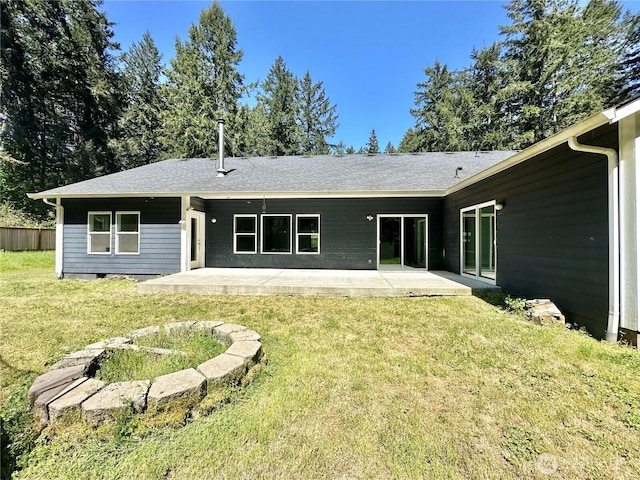 rear view of property with a lawn and a patio area