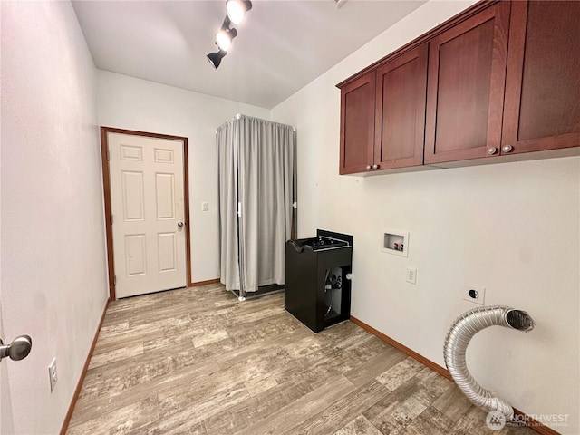 laundry room with hookup for an electric dryer, laundry area, baseboards, and light wood finished floors