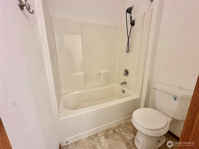 bathroom with toilet and  shower combination