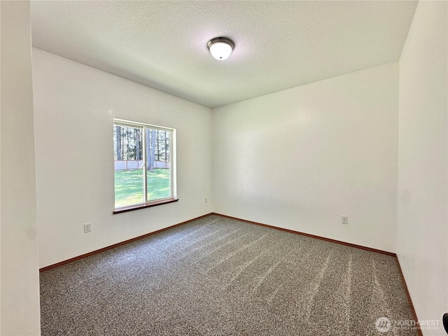 unfurnished room featuring baseboards, a textured ceiling, and carpet