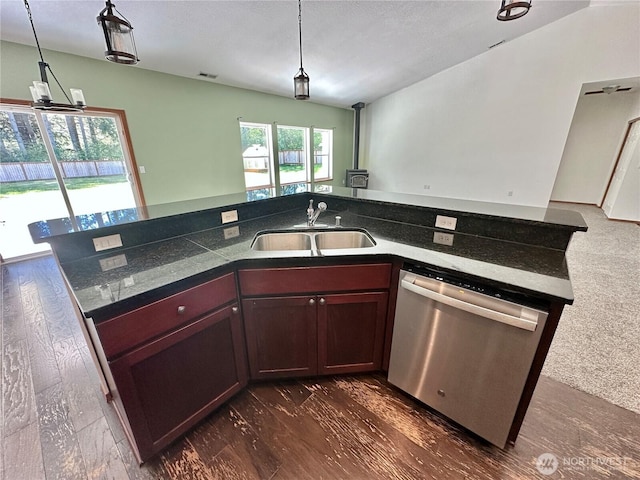 kitchen featuring hanging light fixtures, a sink, visible vents, and dishwasher
