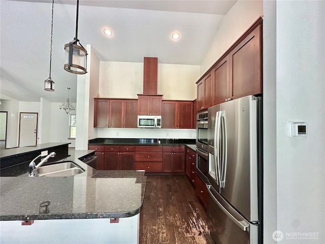 kitchen with recessed lighting, a sink, dark wood finished floors, appliances with stainless steel finishes, and decorative light fixtures