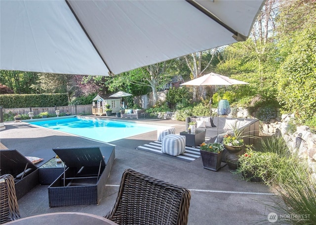 view of swimming pool featuring a fenced backyard, a fenced in pool, outdoor lounge area, and a patio