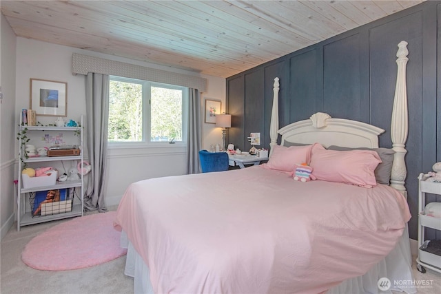bedroom with baseboards, carpet flooring, and wood ceiling
