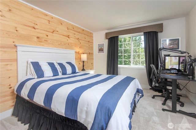 carpeted bedroom with wooden walls