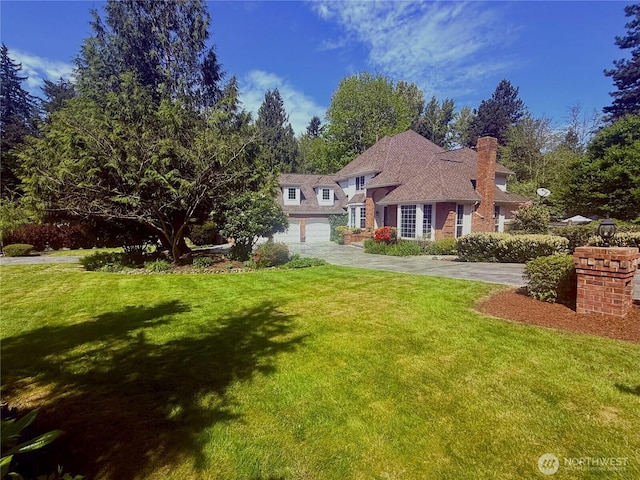 12938 196th Ct NE, Woodinville, WA 98077 - view of front of home featuring concrete driveway, a front lawn, a garage, and a chimney