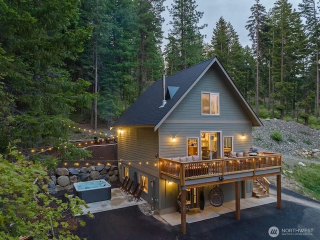 41 Hawkeye, Ronald, WA 98940 - rear view of house featuring roof with shingles, a wooden deck, a patio area, and a view of trees